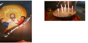 Jesusbild und brennende Kerzen in einer Schale