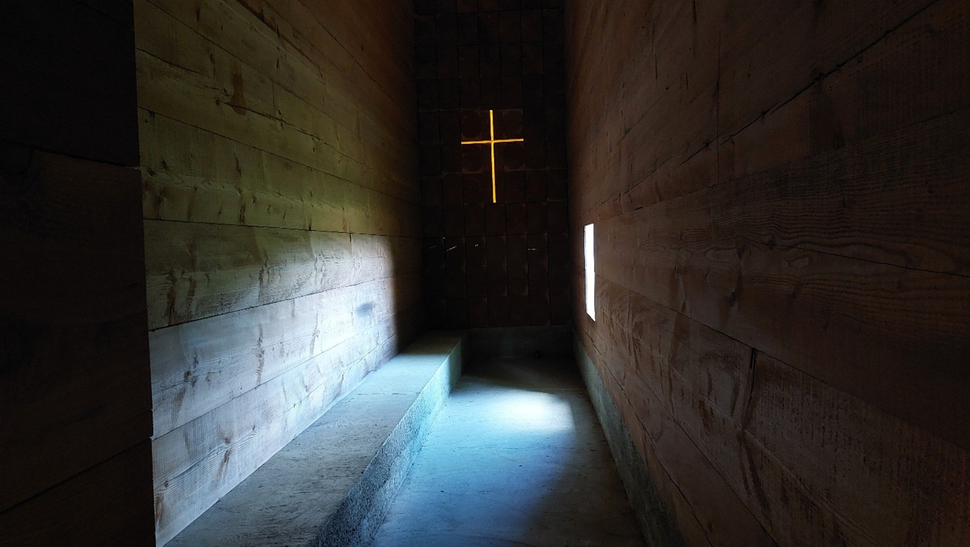 Dunkle schlichte Kapelle mit Kreuz